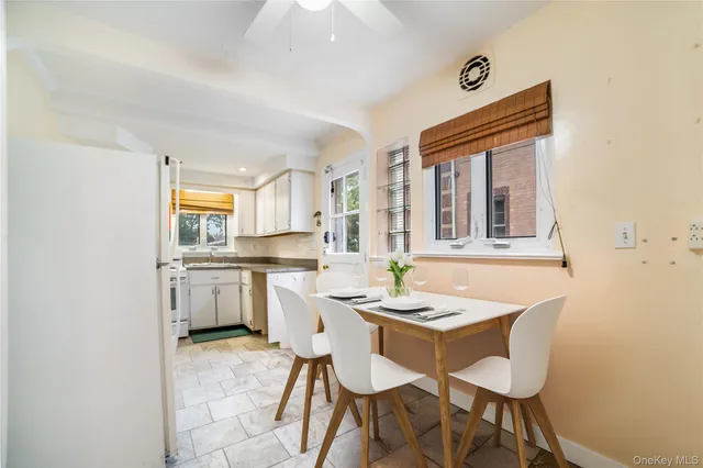 a dining room with a sink a counter and chairs