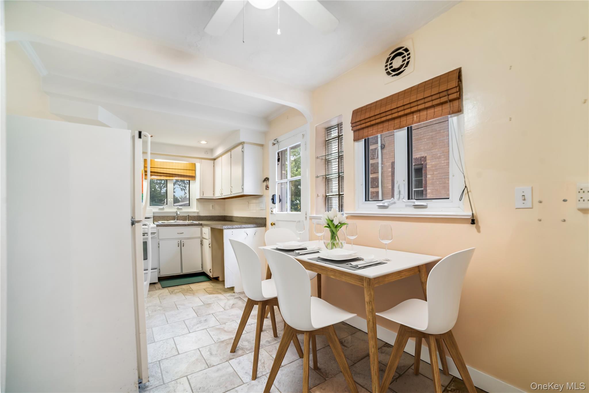 77-19 252nd Street Queens, NY 11426 - Photo 11 of 27 a dining room with a sink a counter and chairs