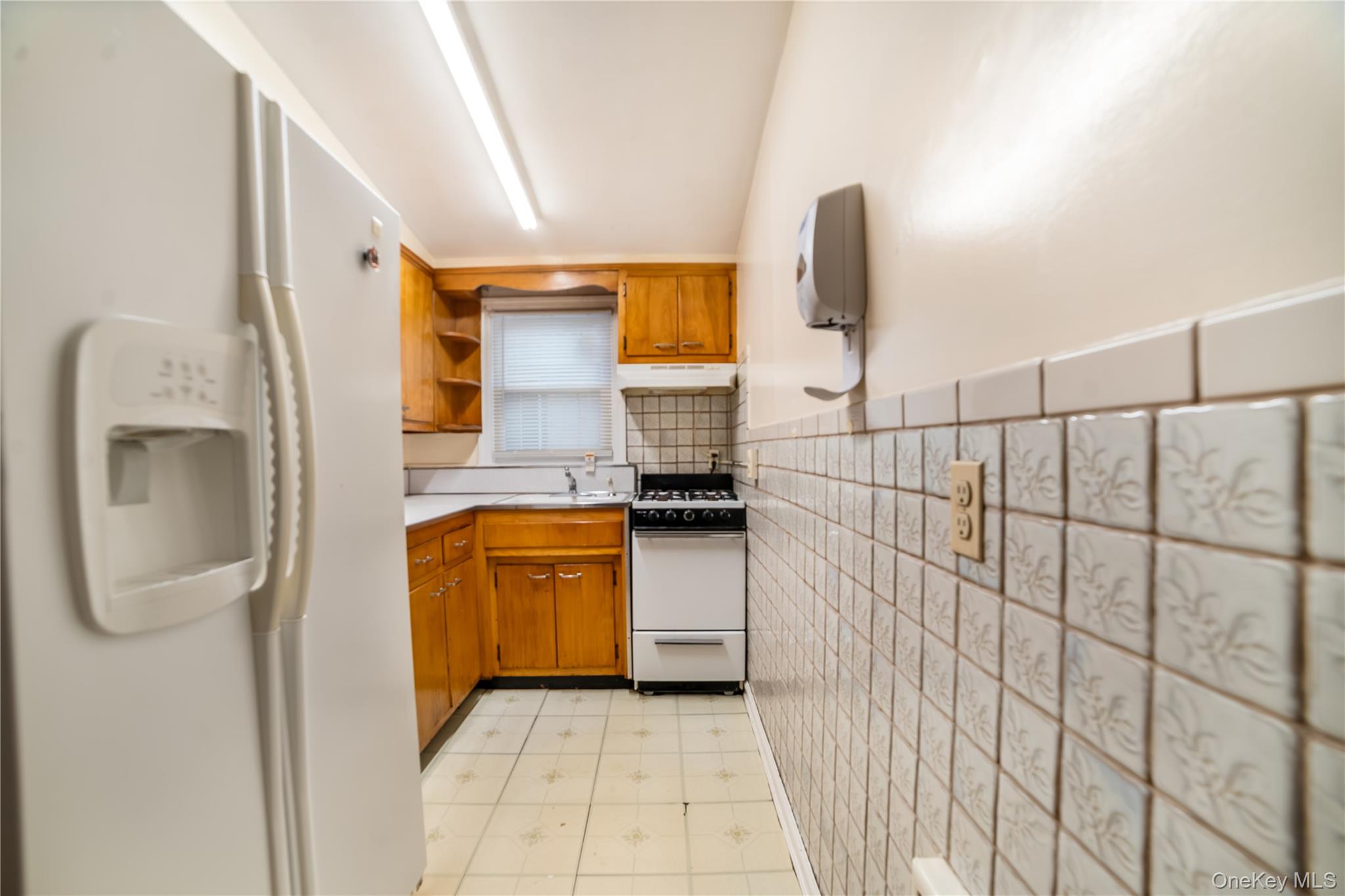 77-19 252nd Street Queens, NY 11426 - Photo 16 of 27 a bathroom with a sink and mirror