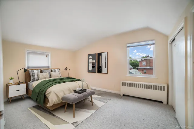 a spacious bedroom with a bed and a window
