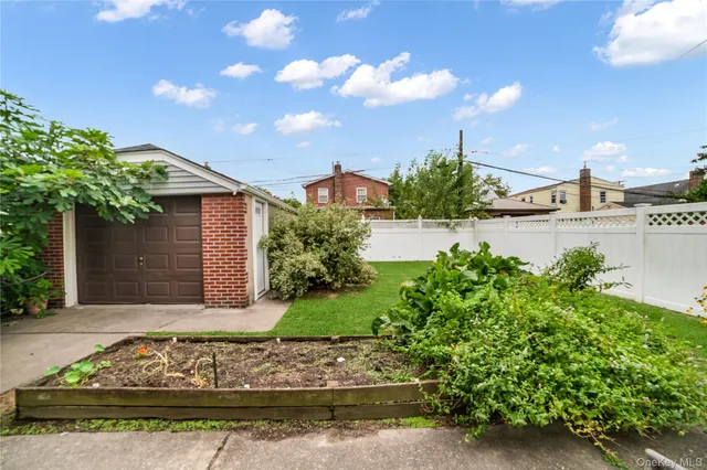 a front view of a house with a yard and potted plants