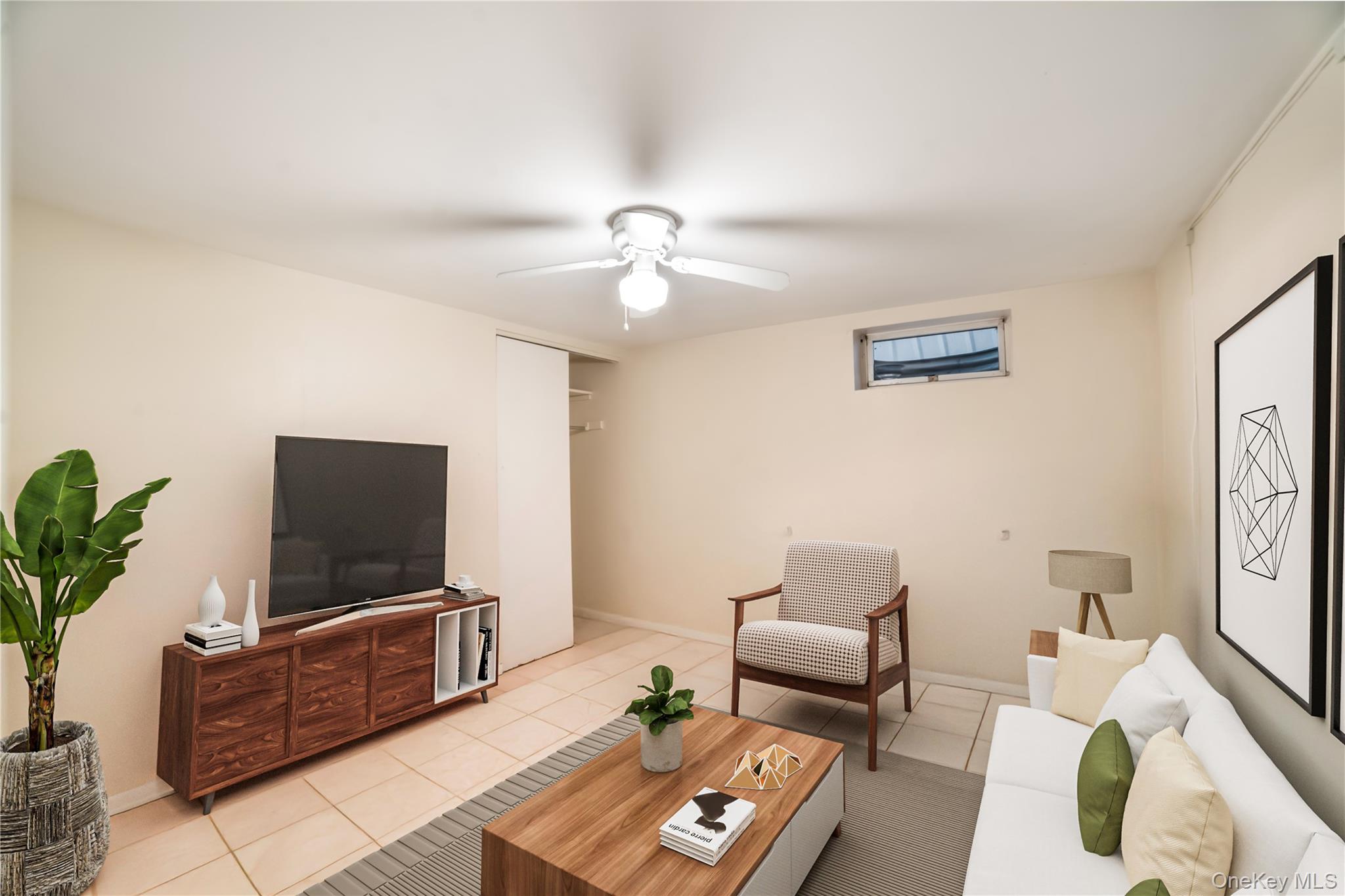 77-19 252nd Street Queens, NY 11426 - Photo 22 of 27 a living room with furniture and a flat screen tv