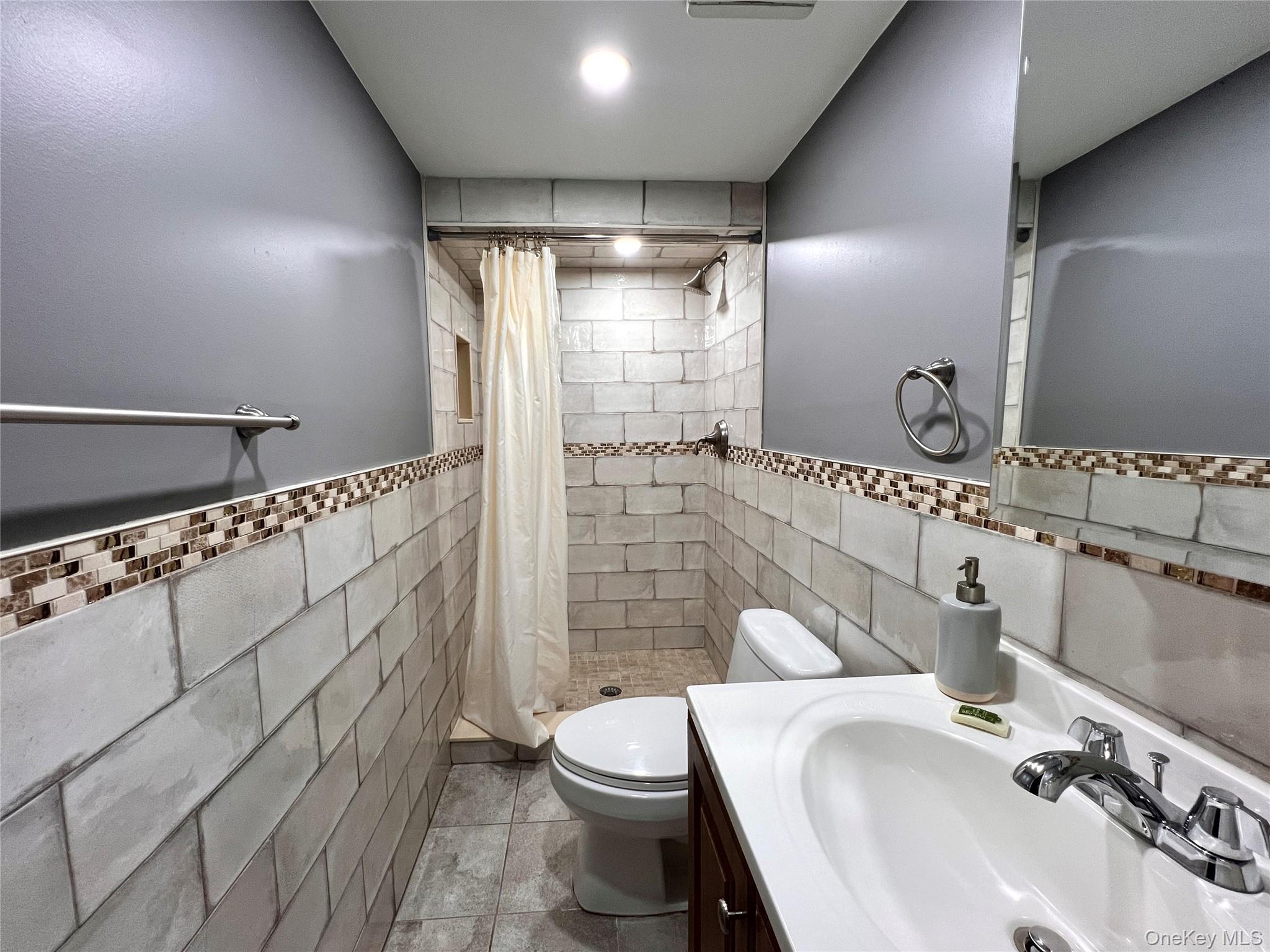 77-19 252nd Street Queens, NY 11426 - Photo 23 of 27 a bathroom with a sink a toilet and shower