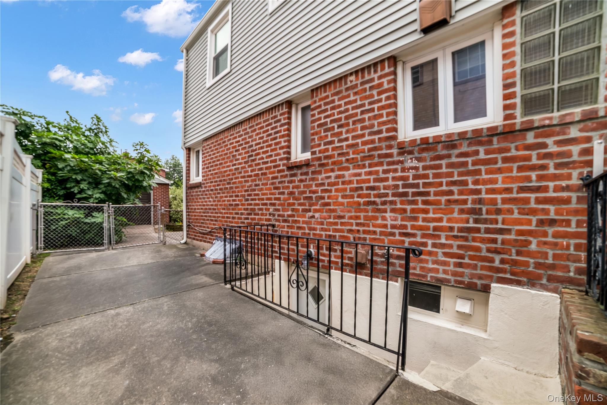 77-19 252nd Street Queens, NY 11426 - Photo 25 of 27 a view of a brick house with wooden fence