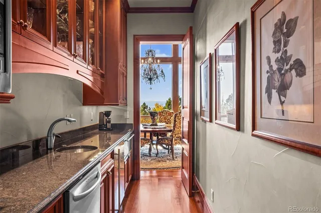 a kitchen with stainless steel appliances granite countertop a sink and a stove