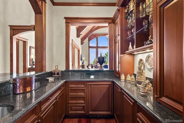 a kitchen with granite countertop a sink and a stove