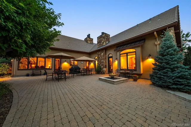 a view of a patio with table and chairs and floor to ceiling window