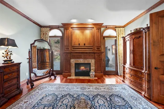 a living room with fireplace furniture and a rug