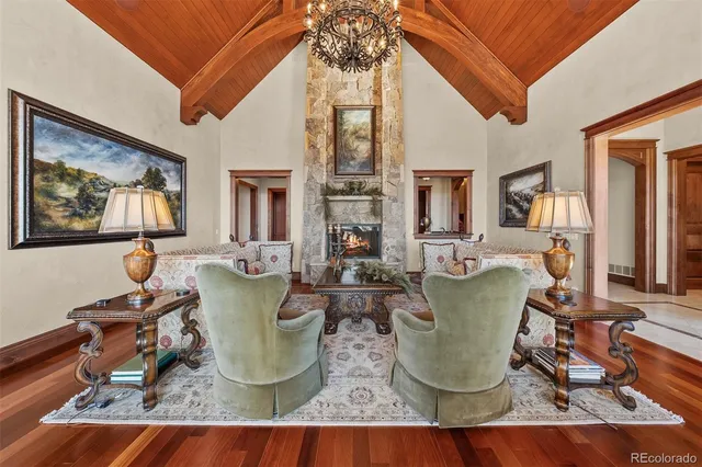 a dining room with wooden floor and glass windows