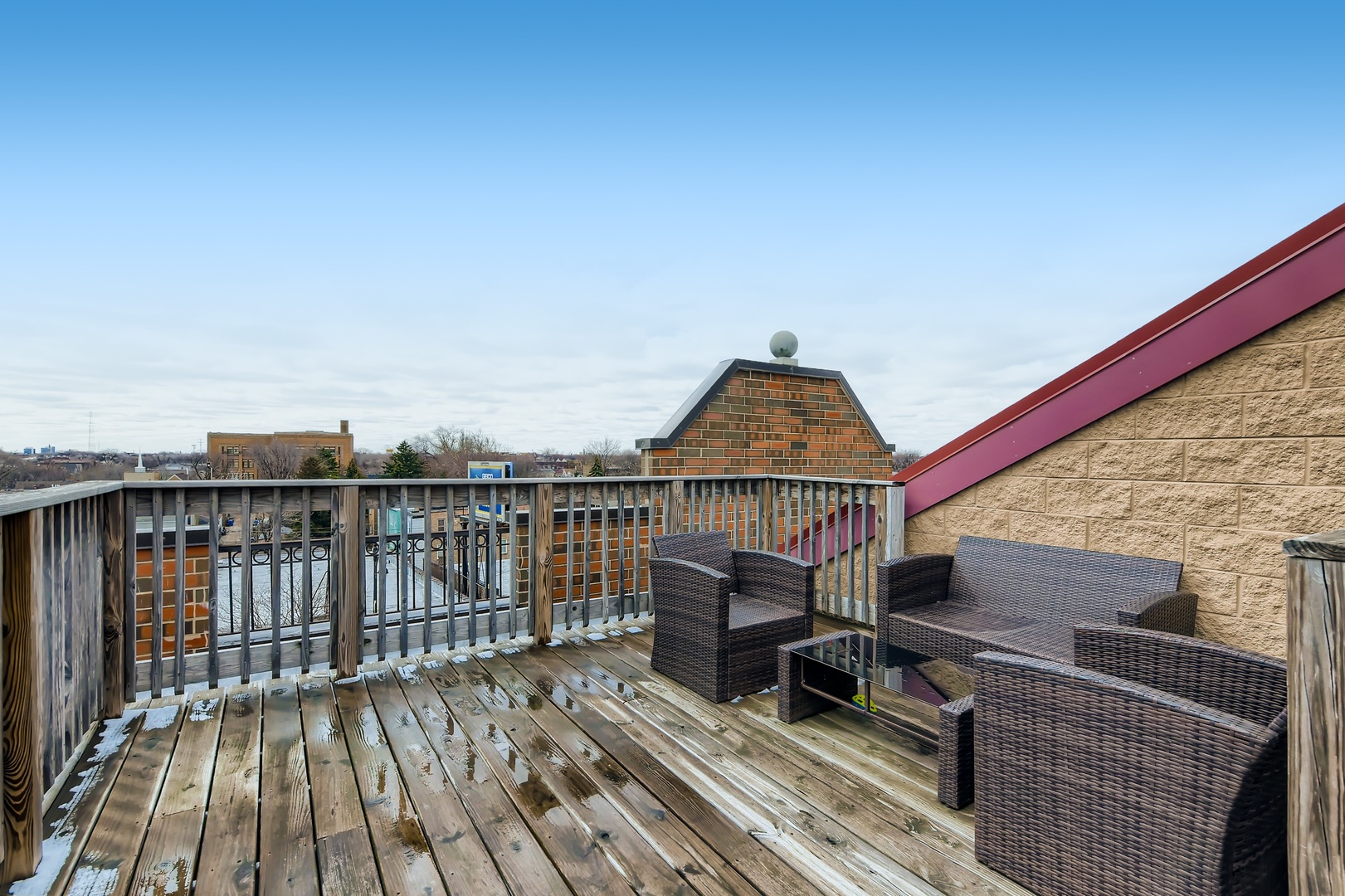 3114 West Irving Park Road, Unit 4E Chicago, IL 60618 - Photo 16 of 18 a view of balcony with wooden floor and fence