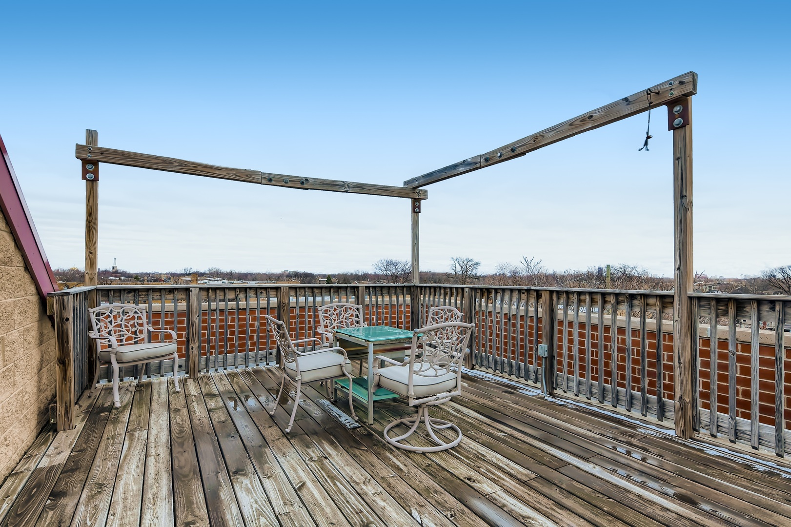 3114 West Irving Park Road, Unit 4E Chicago, IL 60618 - Photo 17 of 18 a view of a balcony with wooden floor and seating space