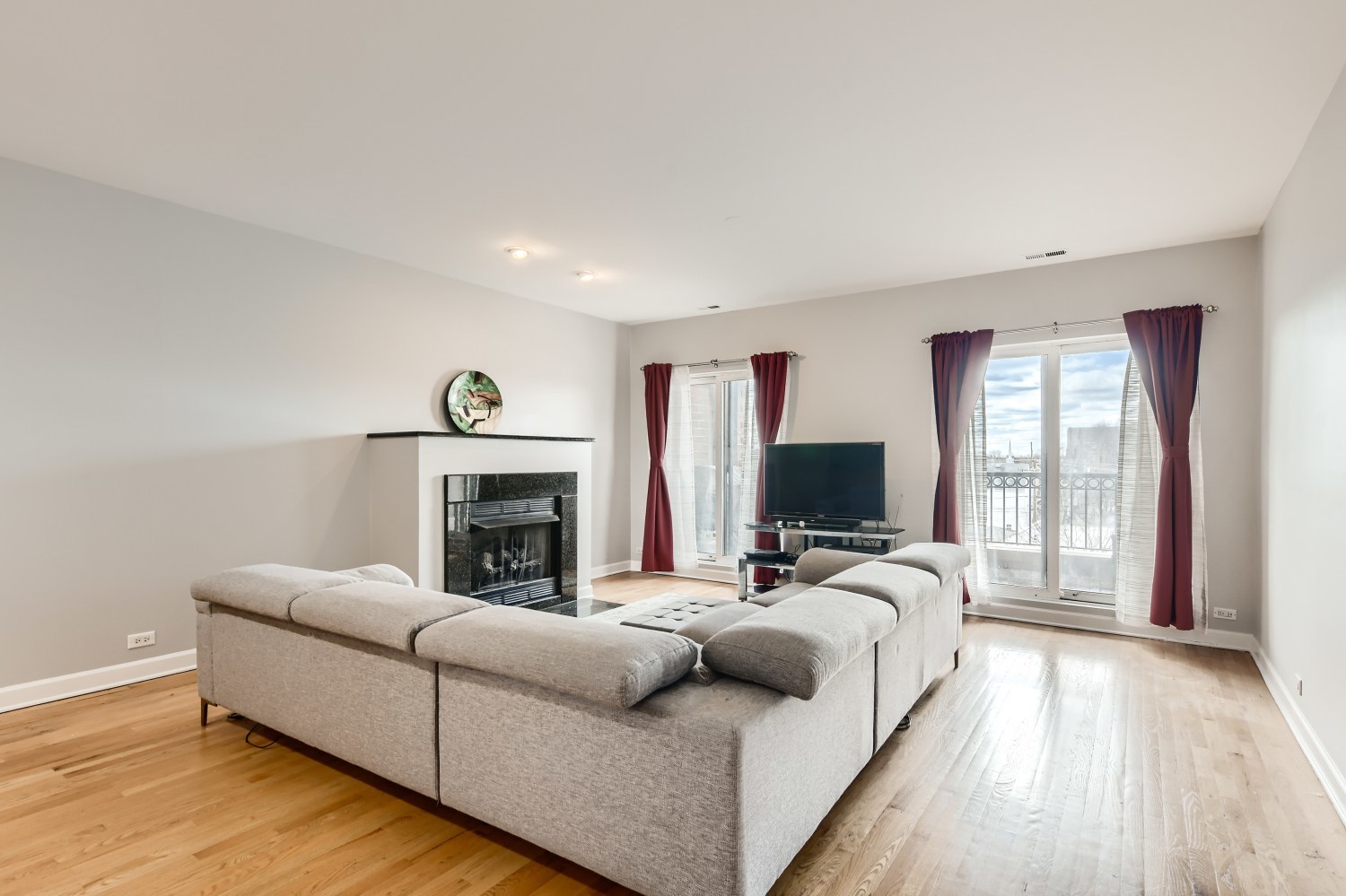 3114 West Irving Park Road, Unit 4E Chicago, IL 60618 - Photo 5 of 18 a living room with furniture and a fireplace