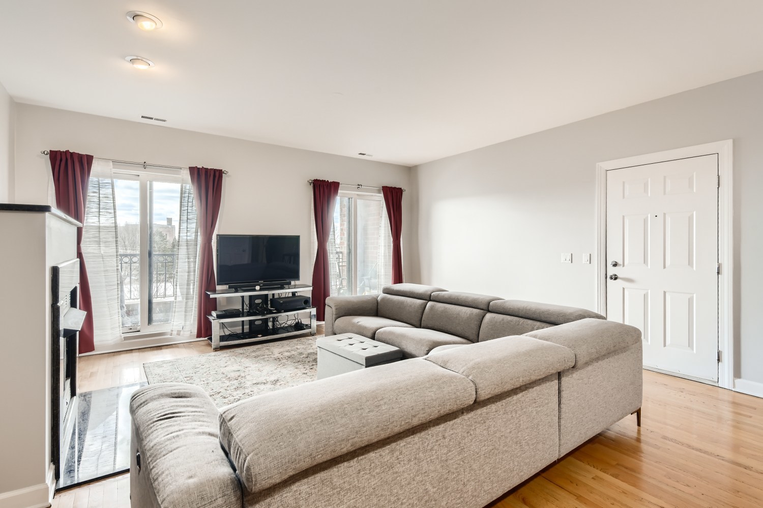 3114 West Irving Park Road, Unit 4E Chicago, IL 60618 - Photo 6 of 18 a living room with furniture and a flat screen tv