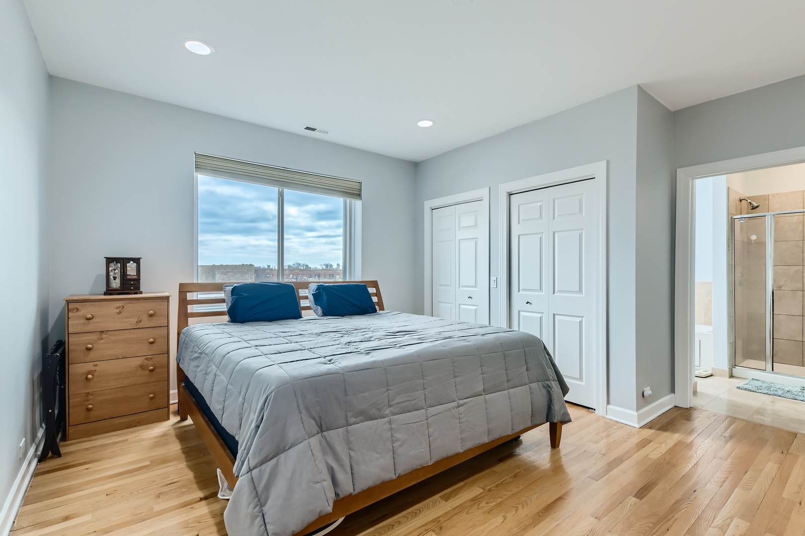 3114 West Irving Park Road, Unit 4E Chicago, IL 60618 - Photo 7 of 18 a bedroom with a bed and a dresser