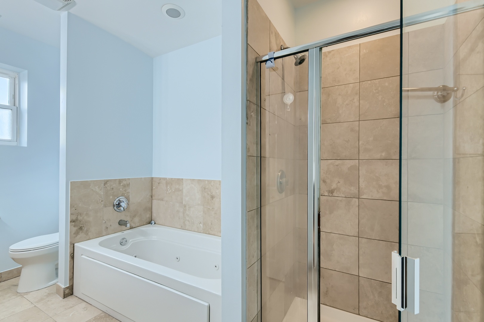 3114 West Irving Park Road, Unit 4E Chicago, IL 60618 - Photo 10 of 18 a bathroom with a bathtub and a shower