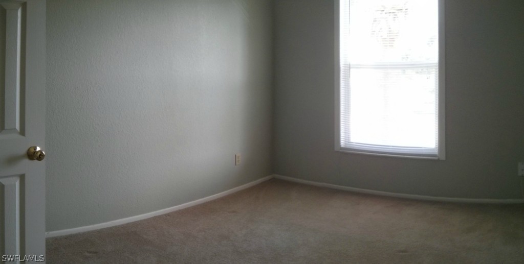 26310 Rampart Boulevard, Unit 505E Punta Gorda, FL 33983 - Photo 14 of 17 an empty room with a window