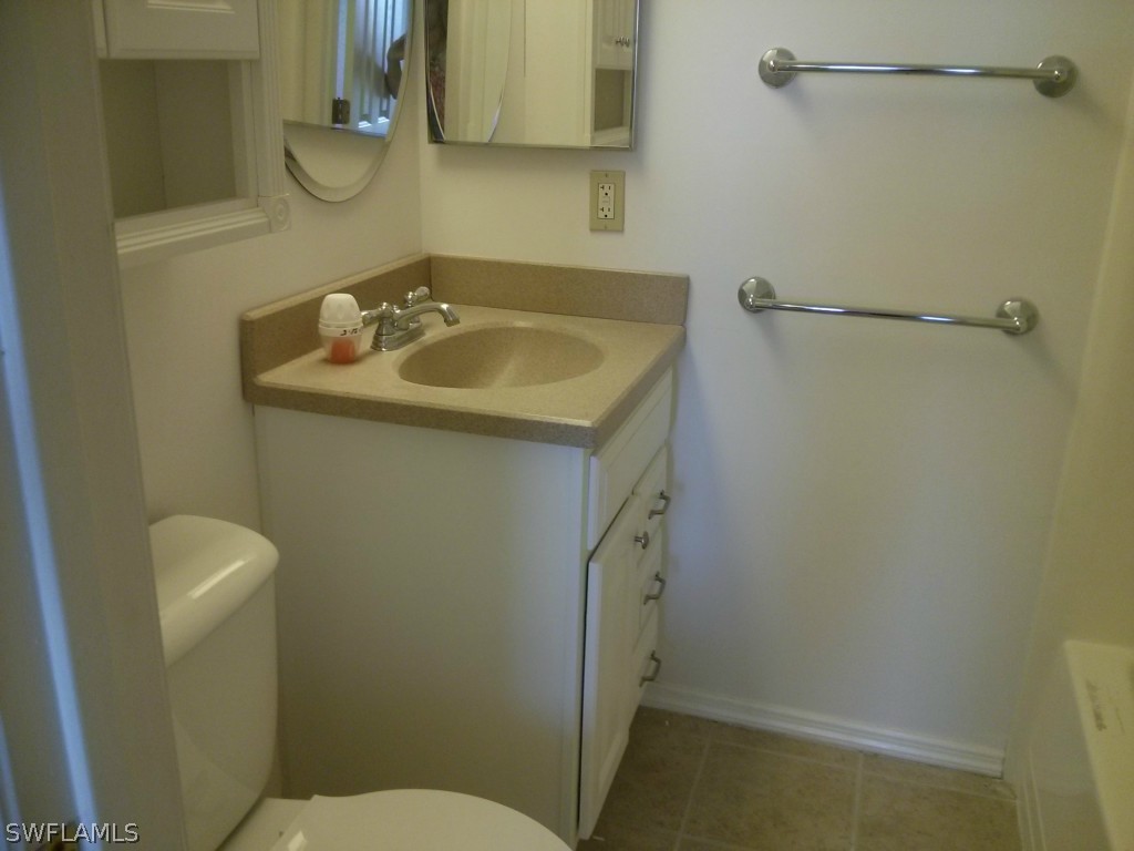 26310 Rampart Boulevard, Unit 505E Punta Gorda, FL 33983 - Photo 15 of 17 a bathroom with a sink and mirror