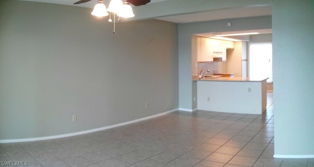 26310 Rampart Boulevard, Unit 505E Punta Gorda, FL 33983 - Photo 5 of 17 en empty room with window and wooden floor
