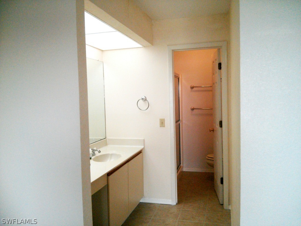 26310 Rampart Boulevard, Unit 505E Punta Gorda, FL 33983 - Photo 10 of 17 a bathroom with a sink a toilet and shower