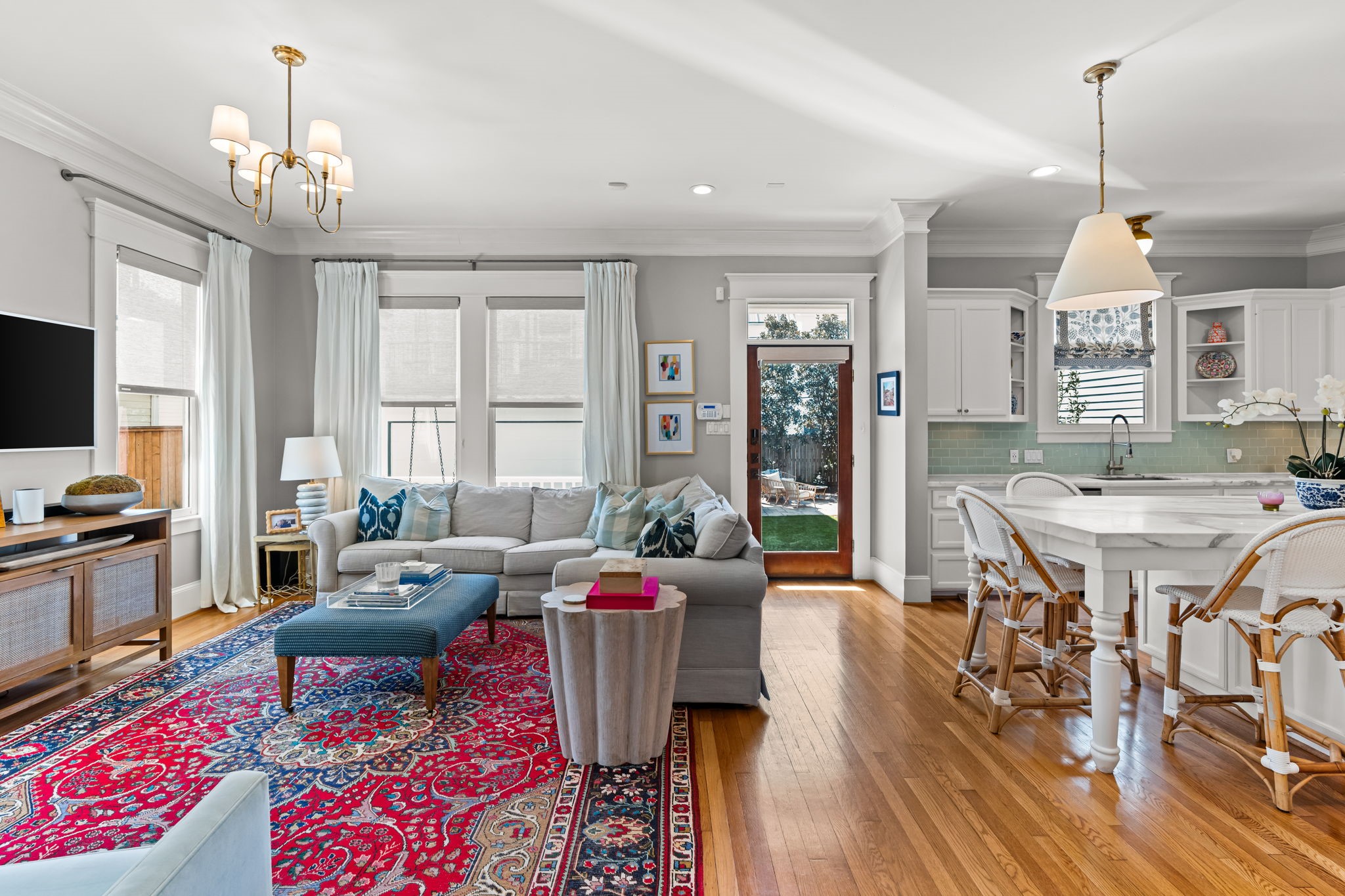 1236 Omar Street Houston, TX 77008 - Photo 11 of 50 The spacious family room opens seamlessly to the kitchen, creating a true heart-of-the-home layout. Large windows and glass doors bring in natural light and provide views of the backyard green space.