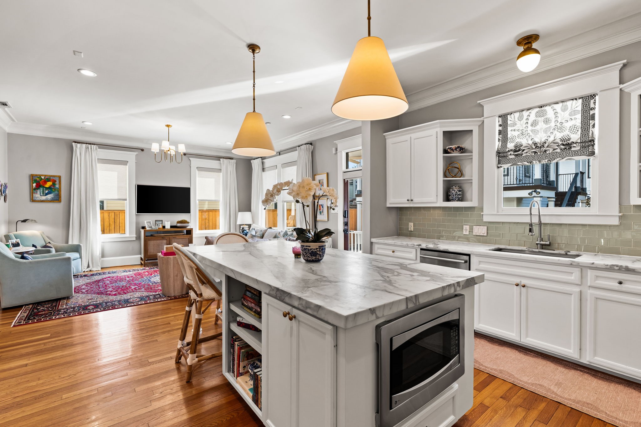 1236 Omar Street Houston, TX 77008 - Photo 17 of 50 Custom cabinetry extends throughout the space, offering abundant storage and thoughtful organization. The open layout maintains connection to the family room, reinforcing the home’s easy, livable flow.