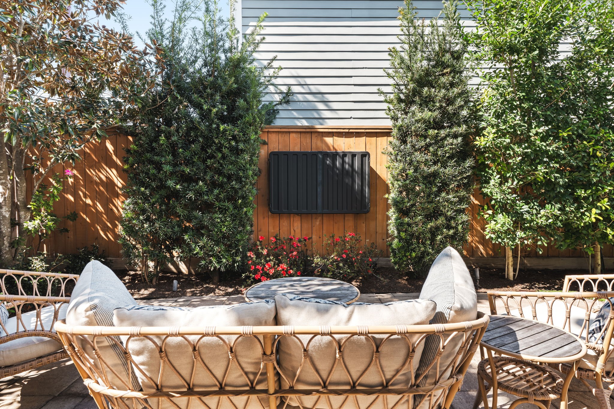 1236 Omar Street Houston, TX 77008 - Photo 32 of 50 A private patio area is nestled along the perimeter fencing, offering an additional outdoor gathering space. Lush landscaping enhances privacy and creates a comfortable courtyard setting.