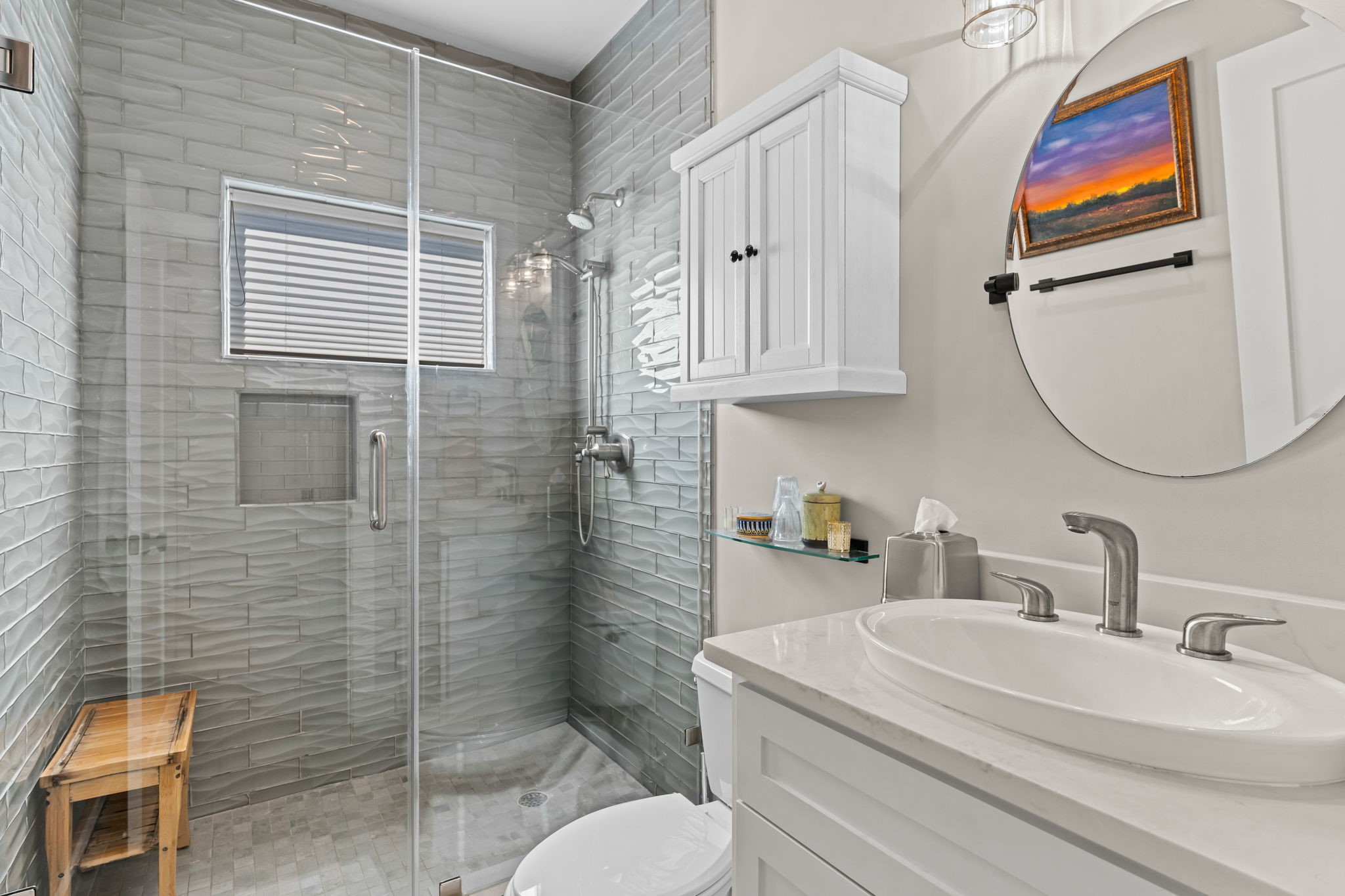 1236 Omar Street Houston, TX 77008 - Photo 37 of 50 This full bath features a walk-in glass shower with dimensional tile surround and a built-in niche. Crisp white cabinetry and modern fixtures create a clean, timeless finish.