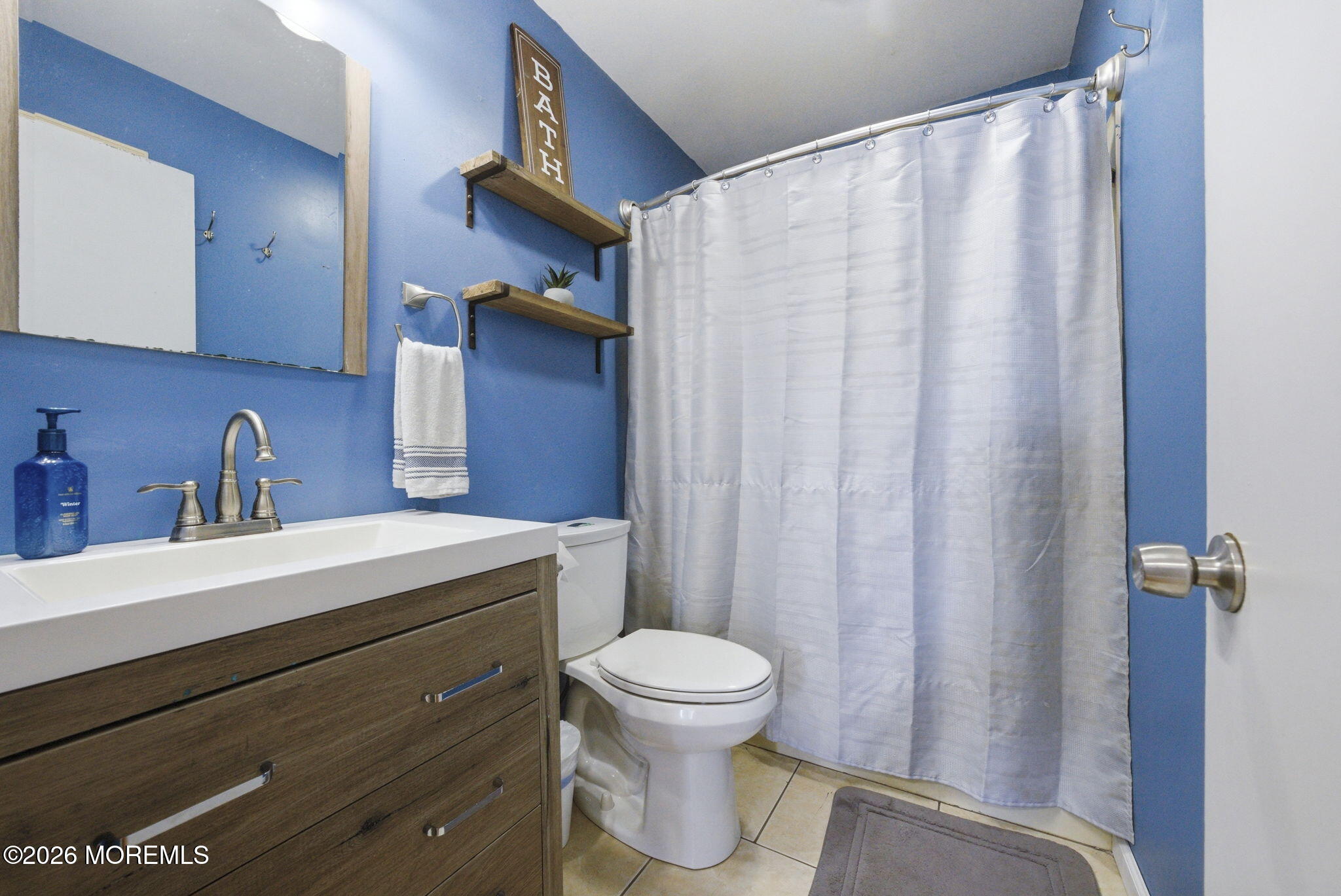 1427 Seminole Road North Brunswick, NJ 08902 - Photo 15 of 45 a bathroom with a sink a toilet and a mirror