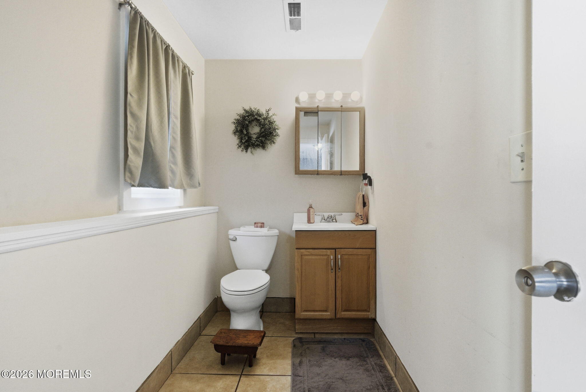 1427 Seminole Road North Brunswick, NJ 08902 - Photo 30 of 45 a bathroom with a toilet sink and mirror