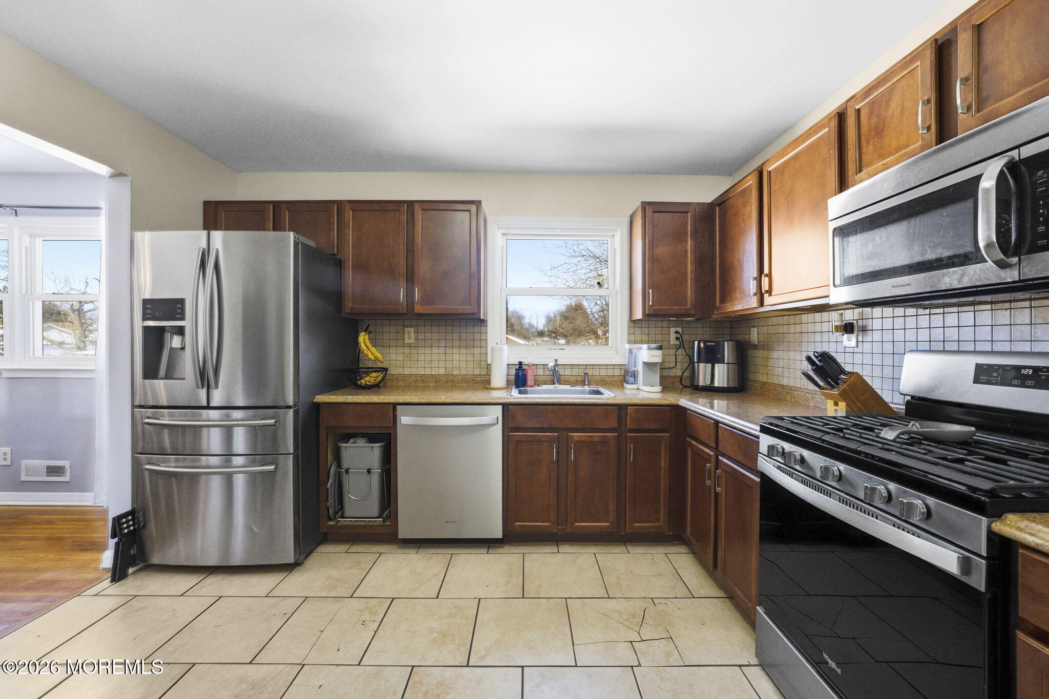 1427 Seminole Road North Brunswick, NJ 08902 - Photo 8 of 45 a kitchen with a refrigerator a stove a sink and cabinets