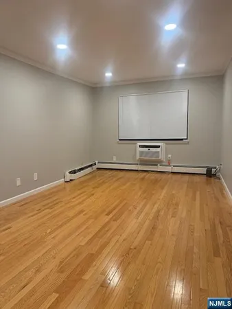 a view of room with wooden floor