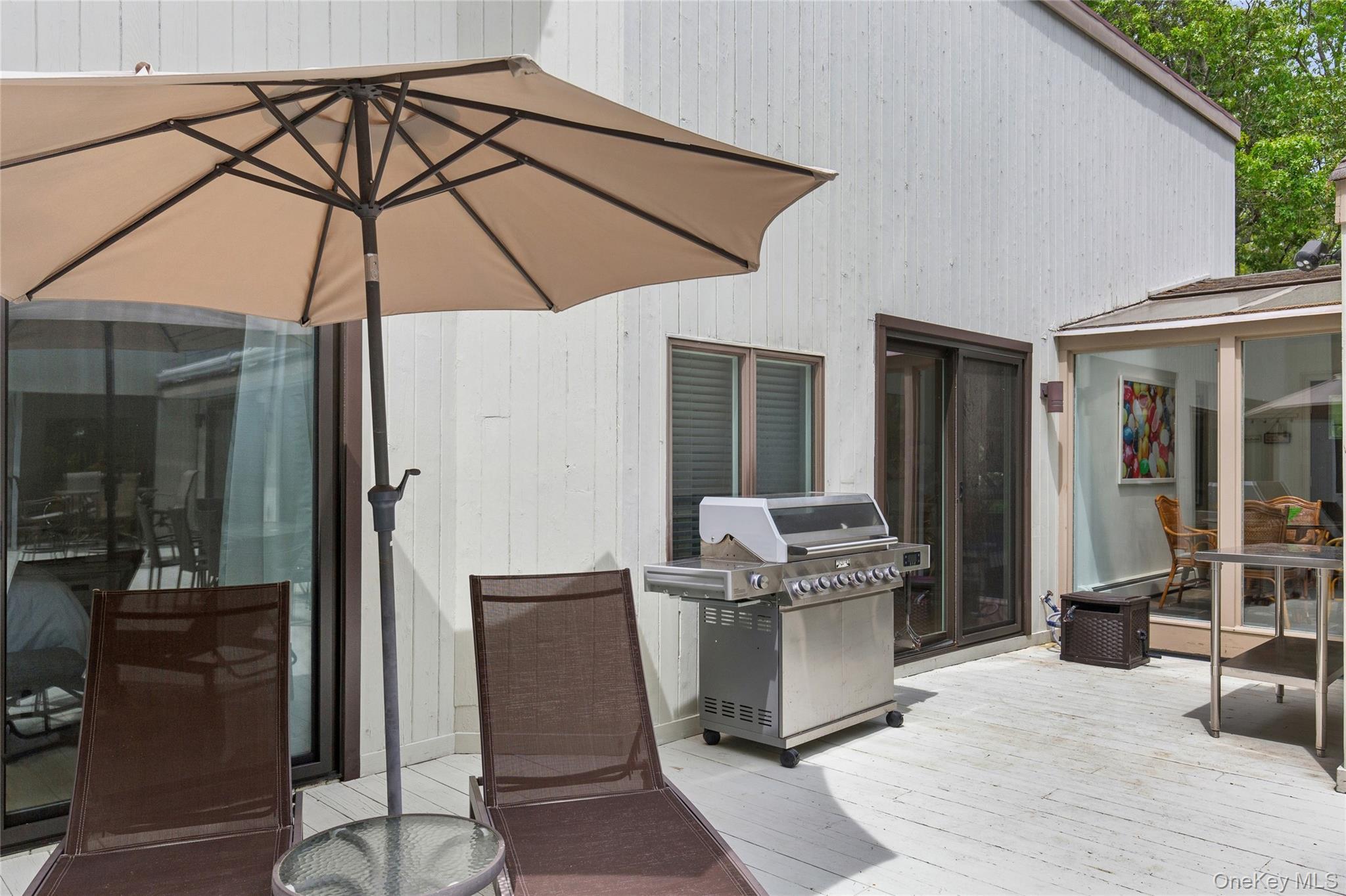 18 Quail Run Hampton Bays, NY 11946 - Photo 13 of 44 a patio with a table and chairs