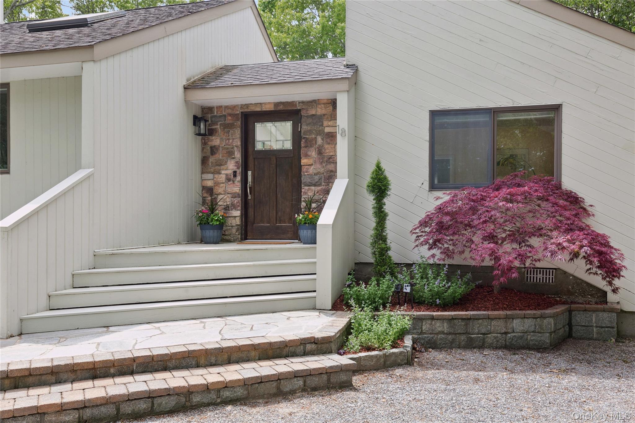 18 Quail Run Hampton Bays, NY 11946 - Photo 14 of 44 a front view of a house with a garden