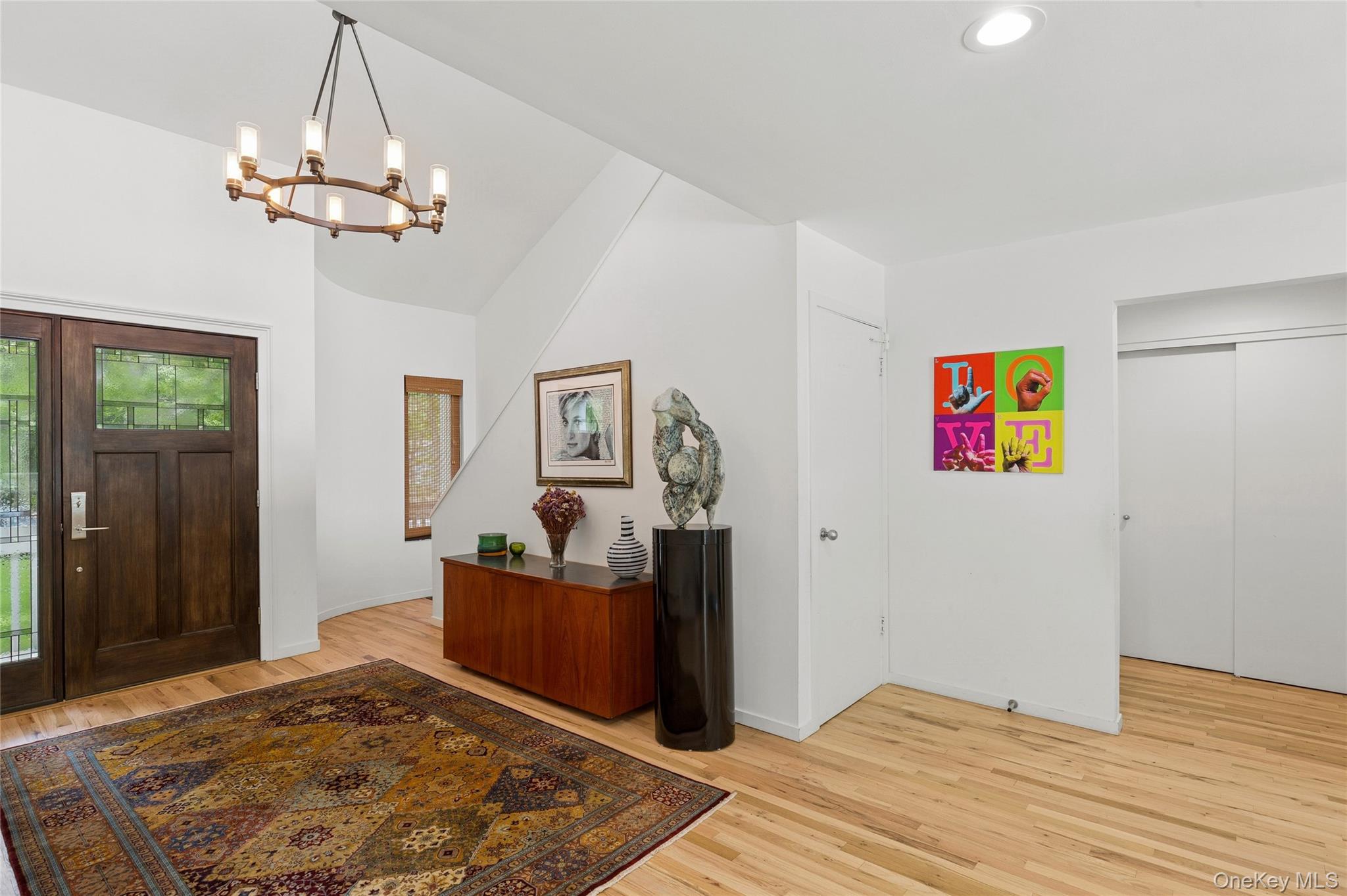 18 Quail Run Hampton Bays, NY 11946 - Photo 20 of 44 a bedroom with a bed and wooden floor