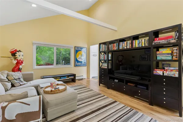 a living room with furniture and painting on the wall