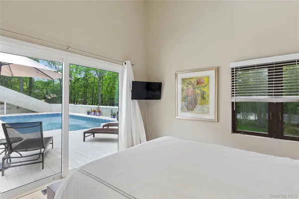 a bedroom with a large bed and a tv