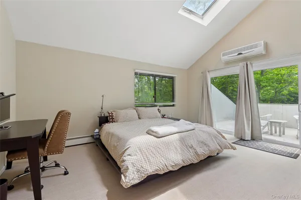 a bedroom with furniture and a flat screen tv