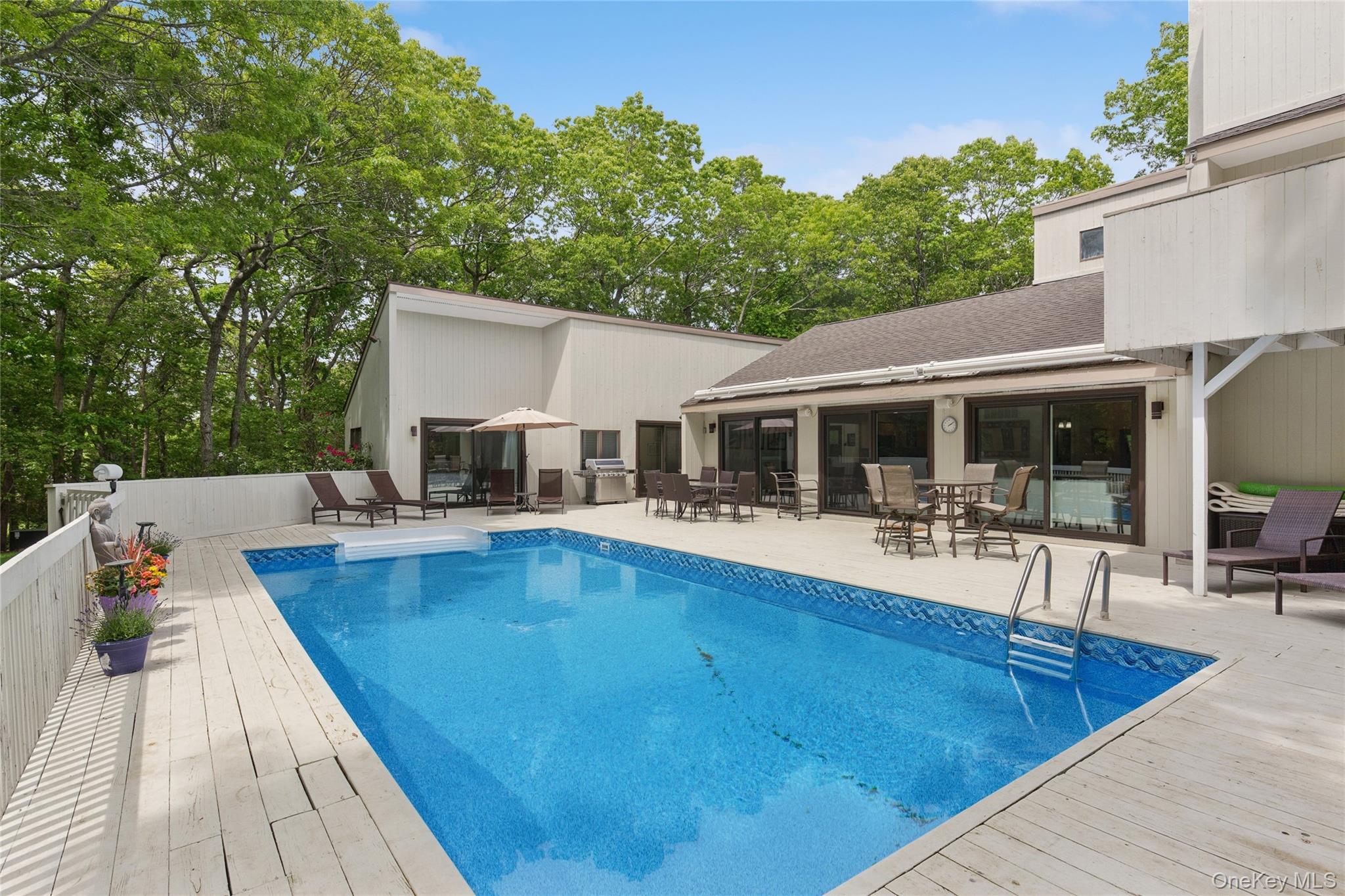 18 Quail Run Hampton Bays, NY 11946 - Photo 4 of 44 a view of a house with swimming pool and sitting area