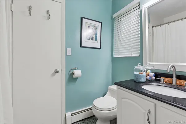 a bathroom with a sink mirror and a window