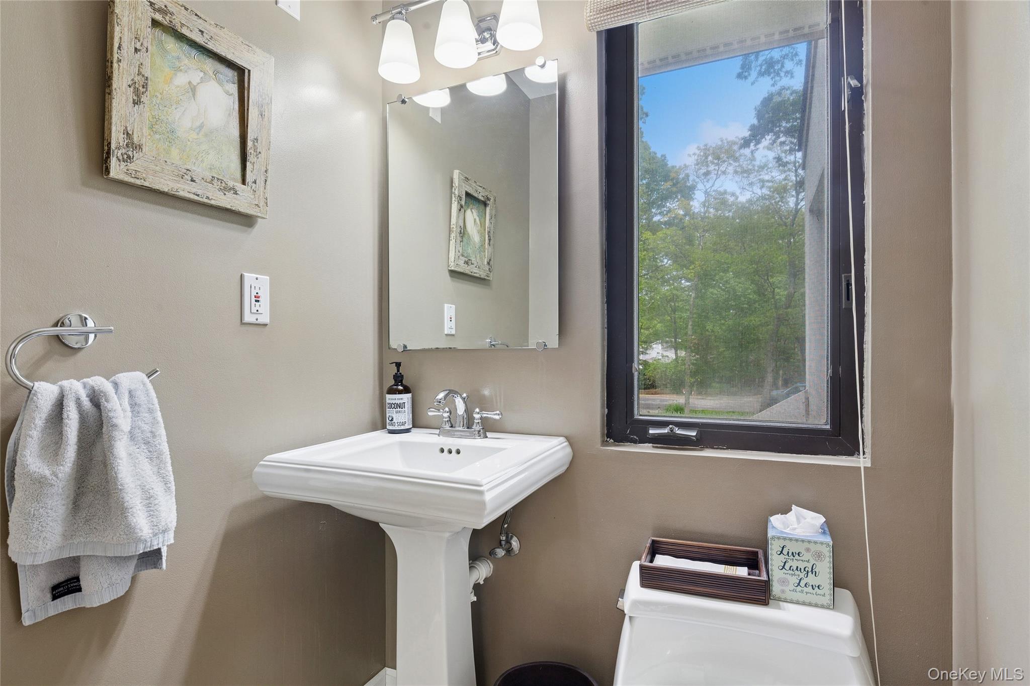 18 Quail Run Hampton Bays, NY 11946 - Photo 43 of 44 a bathroom with a sink mirror and a window
