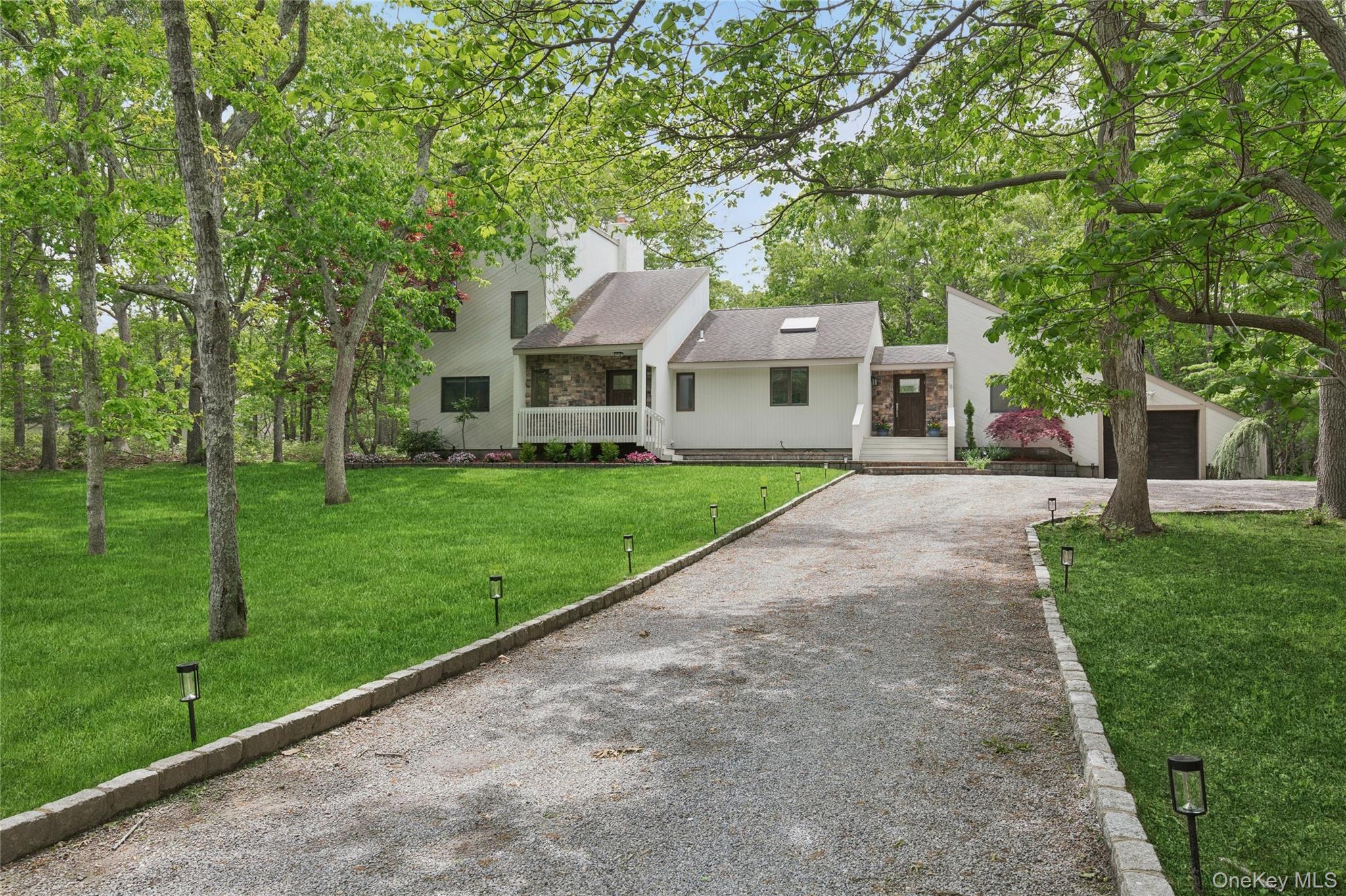 18 Quail Run Hampton Bays, NY 11946 - Photo 44 of 44 a front view of a house with a yard and trees