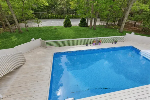 a view of swimming pool with a patio