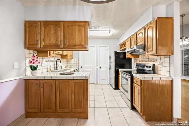 a kitchen with stainless steel appliances granite countertop a sink and cabinets