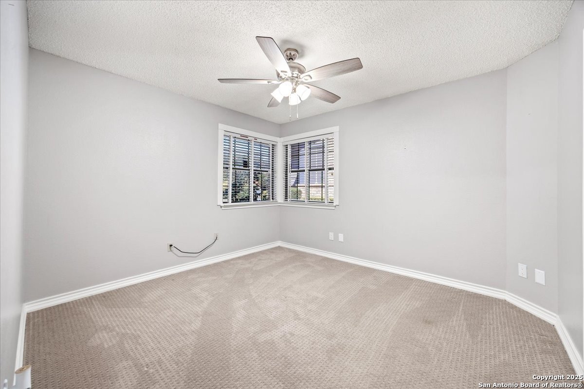 9308 Dover Ridge San Antonio, TX 78250 - Photo 20 of 41 an empty room with a window and a fan