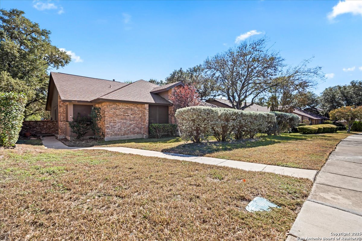9308 Dover Ridge San Antonio, TX 78250 - Photo 2 of 41 a front view of a house with a yard and garage
