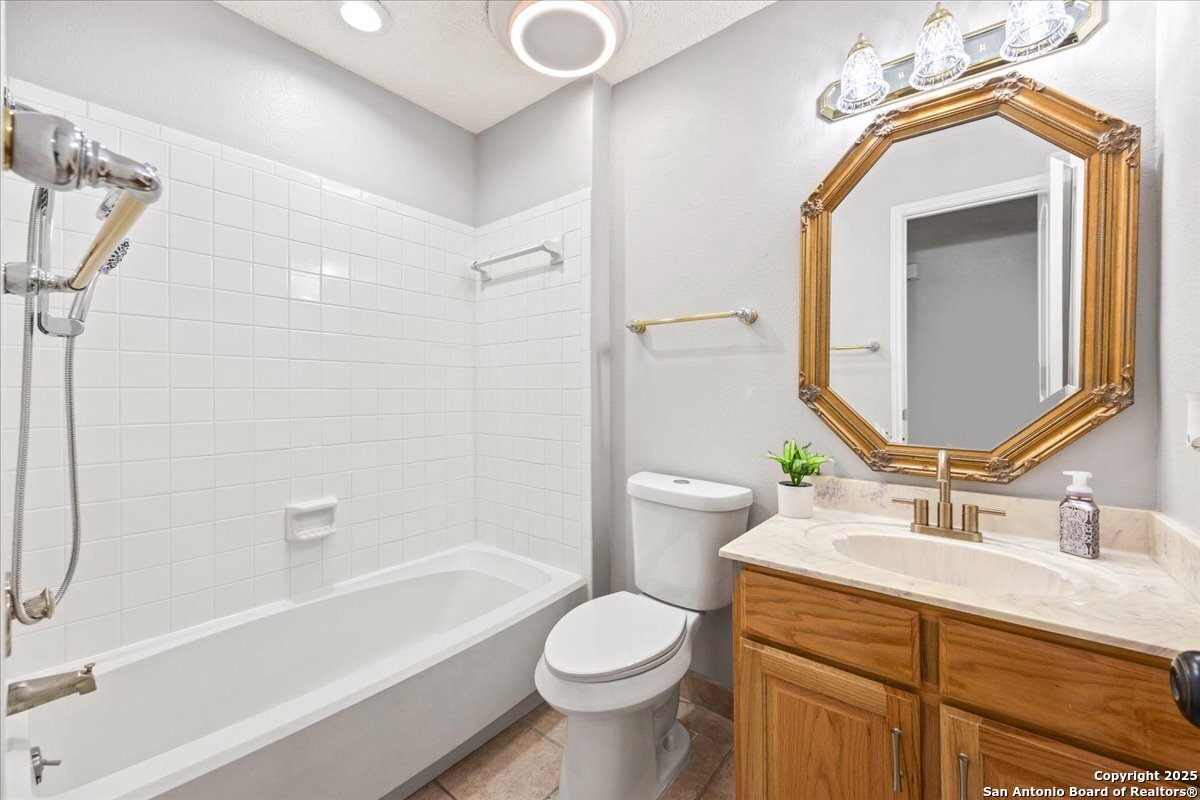 9308 Dover Ridge San Antonio, TX 78250 - Photo 21 of 41 a bathroom with a sink toilet and shower