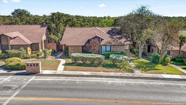 an aerial view of a house with a yard