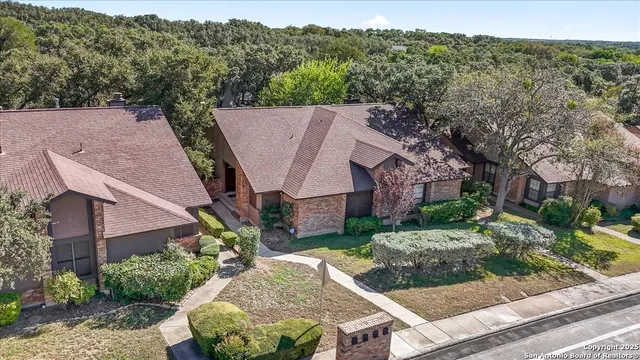 an aerial view of residential houses with outdoor space and street view