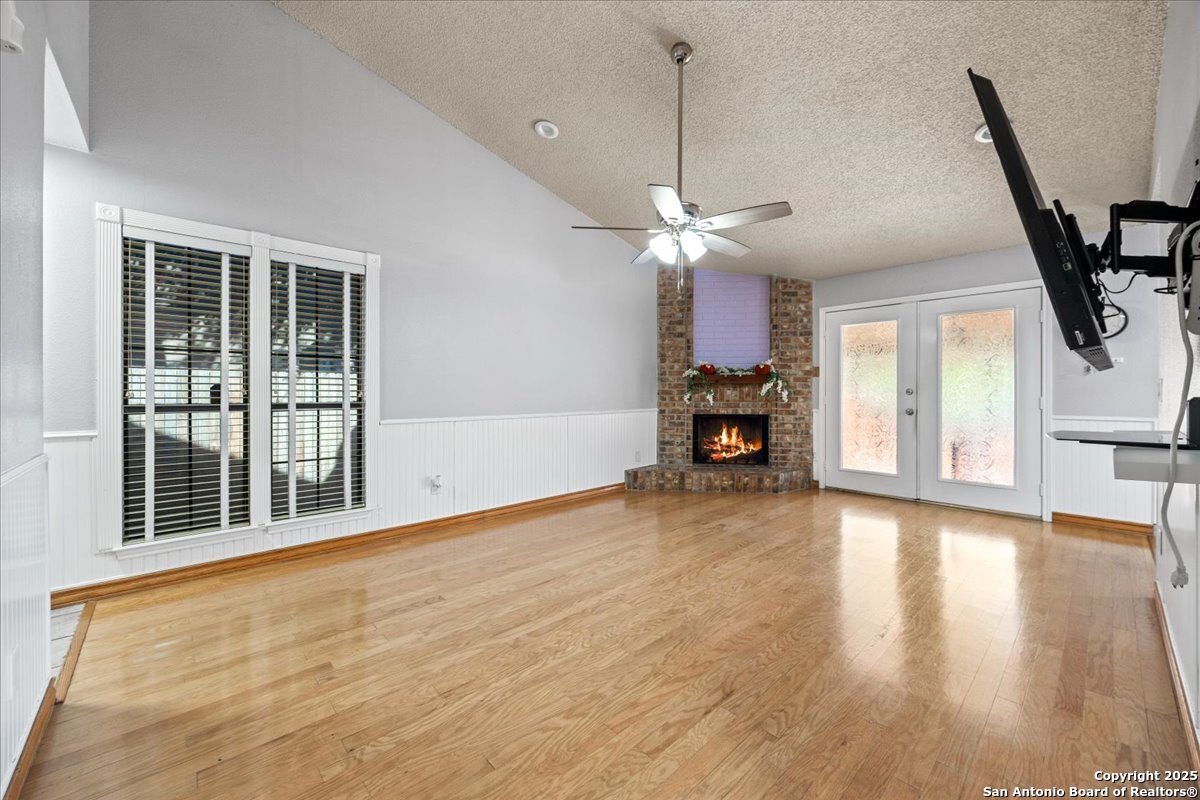 9308 Dover Ridge San Antonio, TX 78250 - Photo 6 of 41 a view of an empty room with a window and wooden floor