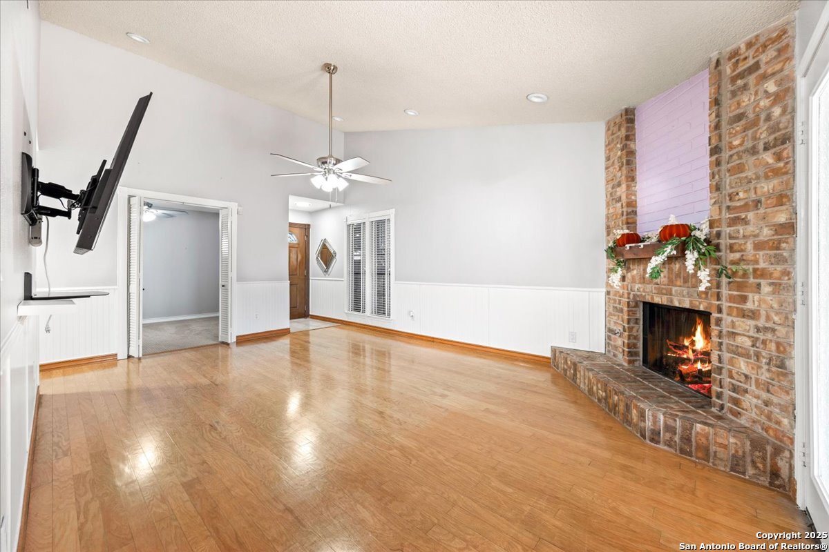 9308 Dover Ridge San Antonio, TX 78250 - Photo 7 of 41 a view of empty room with fireplace and wooden floor